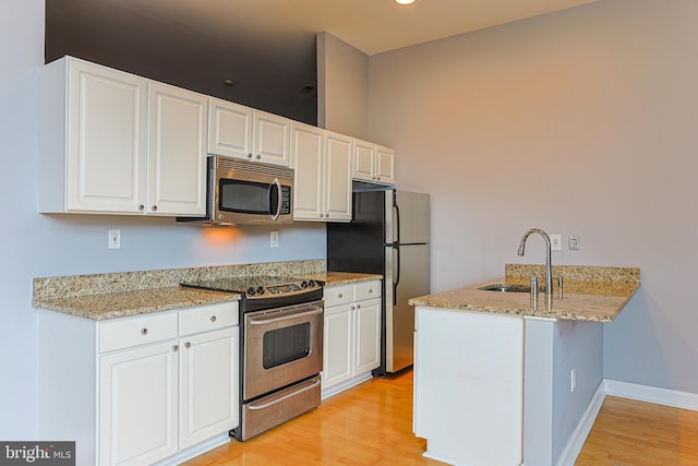 kitchen featuring white cabinets, stainless steel appliances, and sink