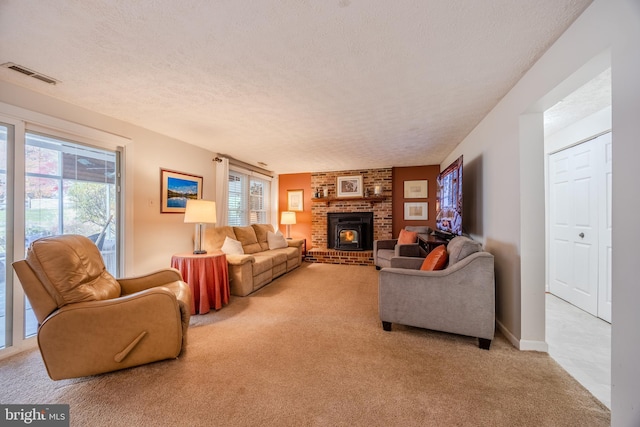 living room featuring a healthy amount of sunlight, light carpet, and a textured ceiling