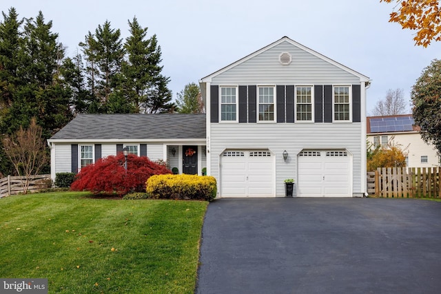 view of front of property featuring a front lawn and a garage