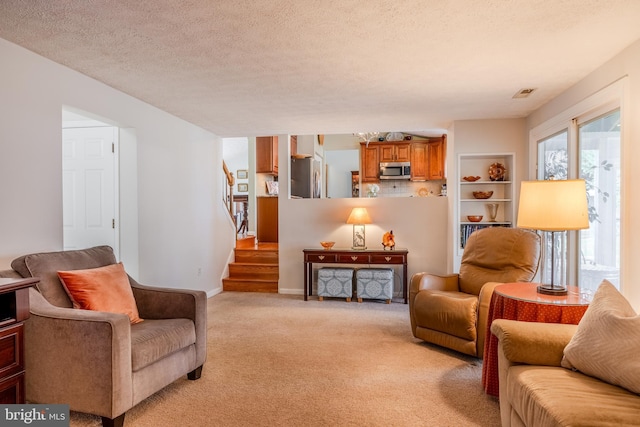 living room with light carpet and a textured ceiling