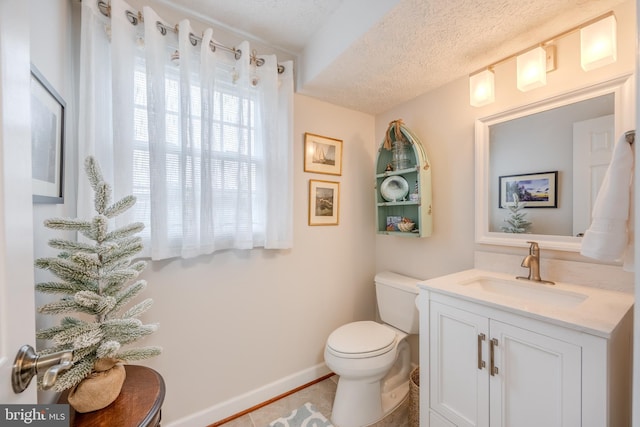 bathroom with vanity, tile patterned floors, toilet, and a textured ceiling