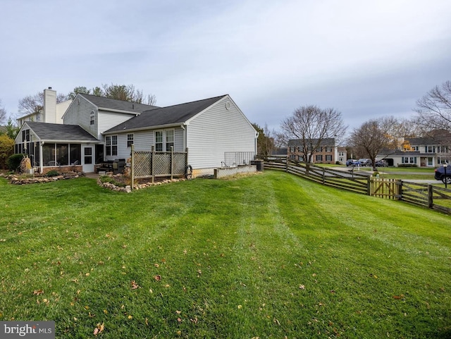 exterior space featuring a sunroom and a yard