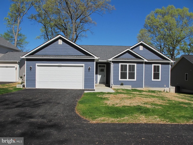 1240 Shore Dr, Colonial Beach, VA 22443 - view of front of home with driveway, an attached garage, and a front yard