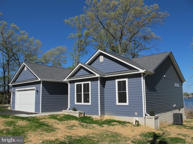 1240 Shore Dr, Colonial Beach, VA 22443 - ranch-style home with a garage, central AC unit, and roof with shingles