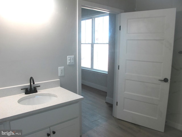 1240 Shore Dr, Colonial Beach, VA 22443 - bathroom featuring plenty of natural light, wood finished floors, and vanity