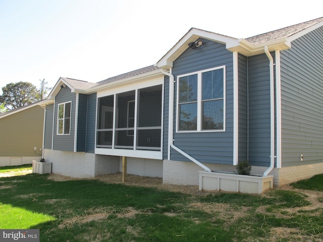 1240 Shore Dr, Colonial Beach, VA 22443 - view of home's exterior featuring a yard and a sunroom