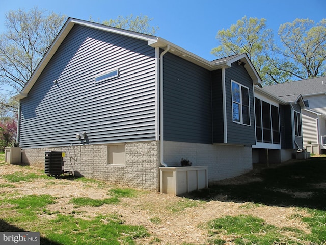 1240 Shore Dr, Colonial Beach, VA 22443 - view of property exterior with central AC and a sunroom