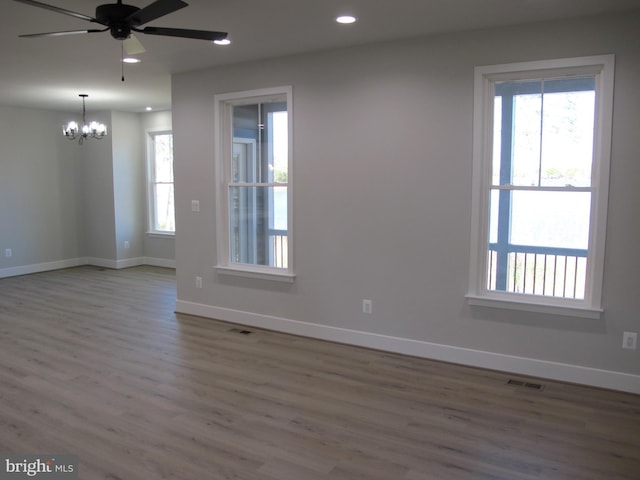 1240 Shore Dr, Colonial Beach, VA 22443 - spare room with wood finished floors, a chandelier, baseboards, healthy amount of natural light, and recessed lighting