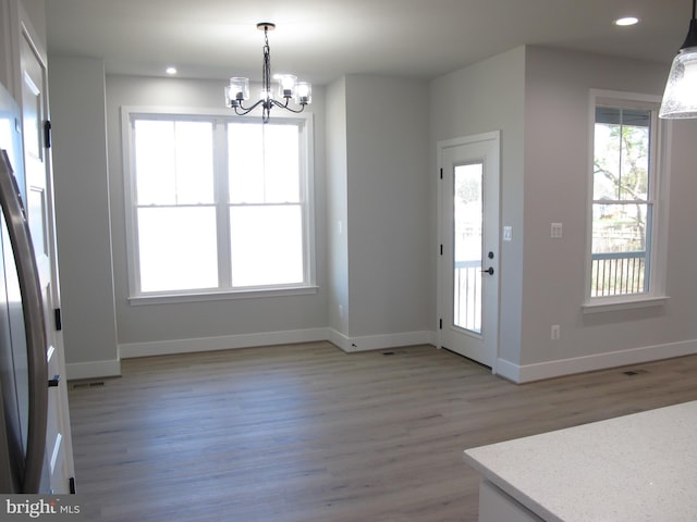 1240 Shore Dr, Colonial Beach, VA 22443 - unfurnished dining area featuring a chandelier, light wood-type flooring, baseboards, and recessed lighting