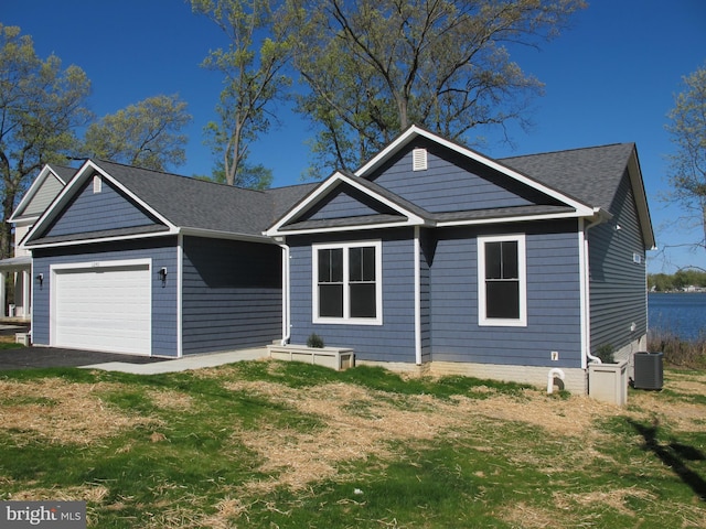 1240 Shore Dr, Colonial Beach, VA 22443 - ranch-style house featuring a garage, central air condition unit, roof with shingles, and driveway
