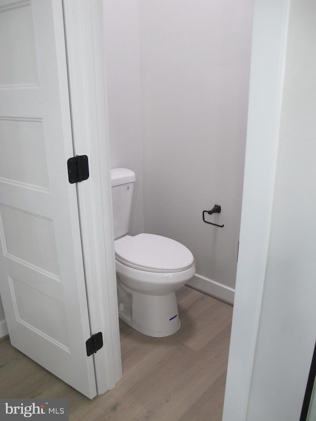 1240 Shore Dr, Colonial Beach, VA 22443 - bathroom featuring wood finished floors, toilet, and baseboards