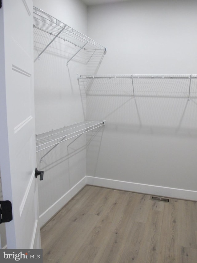 1240 Shore Dr, Colonial Beach, VA 22443 - walk in closet with wood finished floors