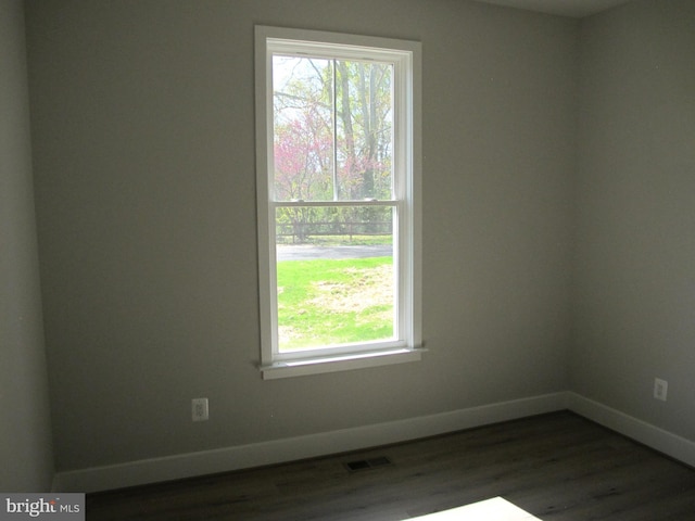 1240 Shore Dr, Colonial Beach, VA 22443 - unfurnished room with baseboards and dark wood-type flooring