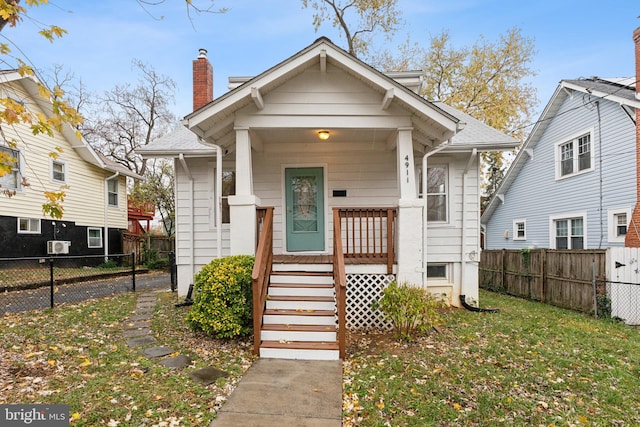 bungalow-style house with a porch and a front yard