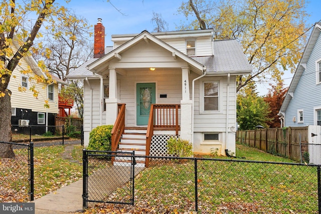 bungalow-style house featuring a porch and a front yard