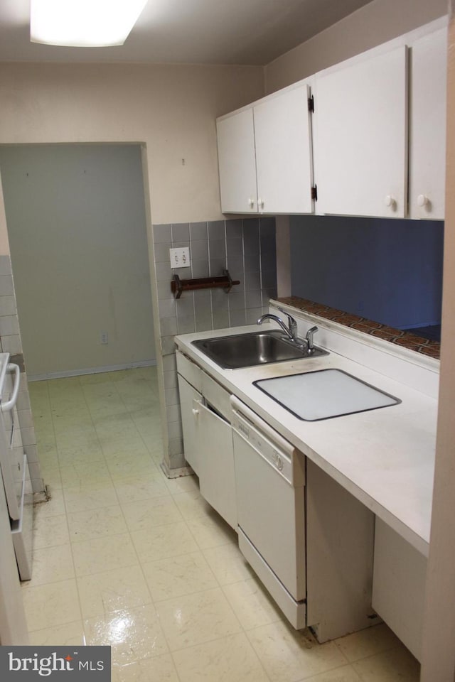 kitchen featuring white cabinets, tasteful backsplash, dishwasher, and sink