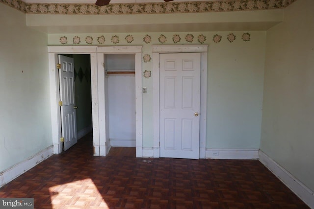 unfurnished bedroom featuring dark parquet floors