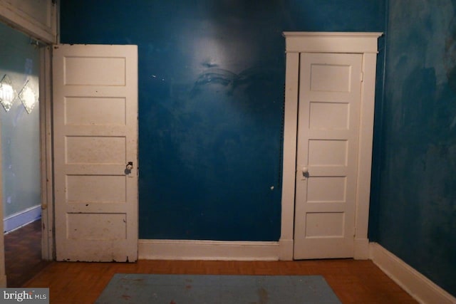 unfurnished room with wood-type flooring