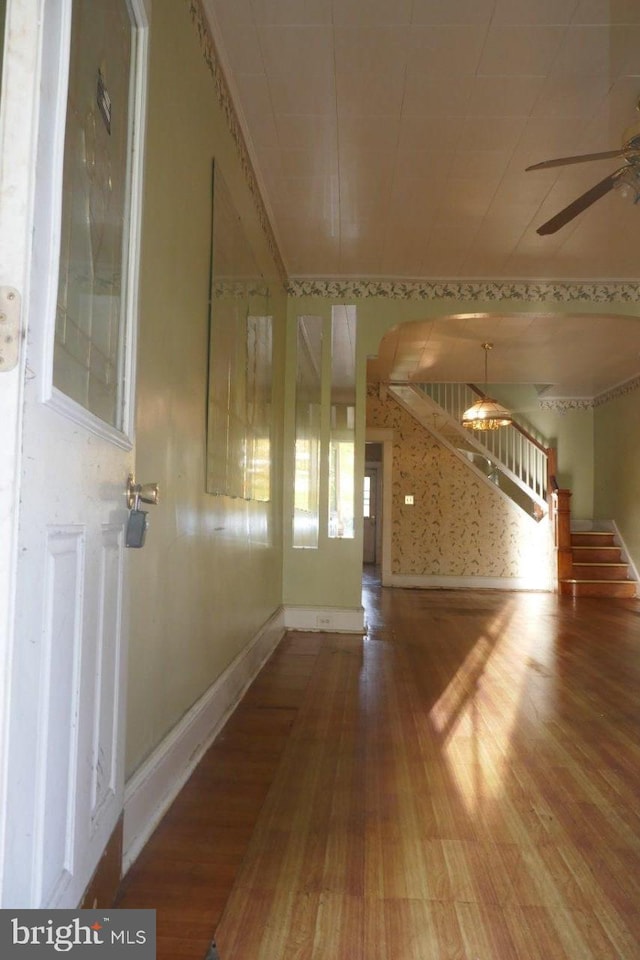 unfurnished living room with ceiling fan and wood-type flooring