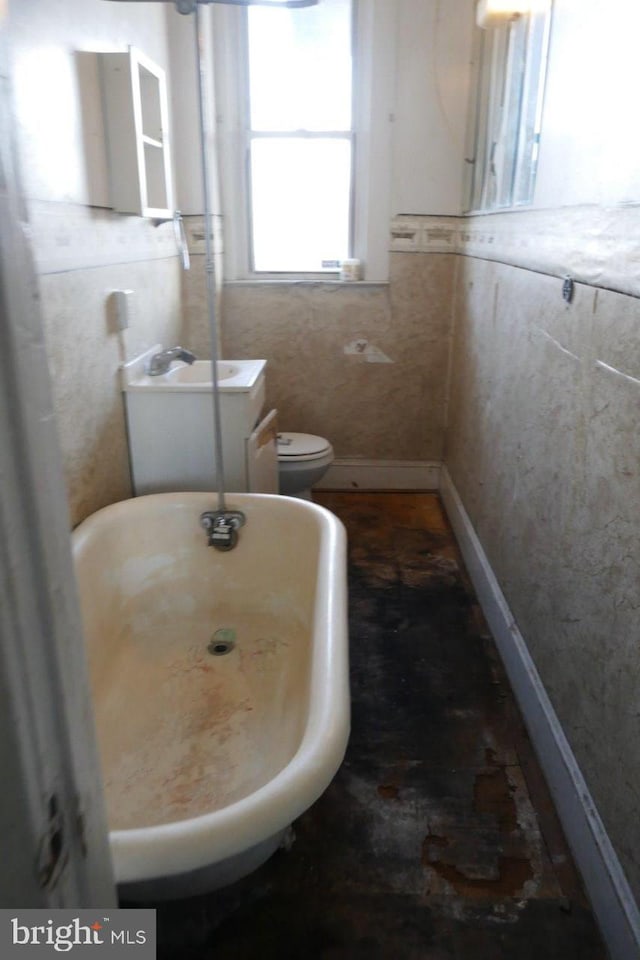 bathroom featuring toilet and a tub