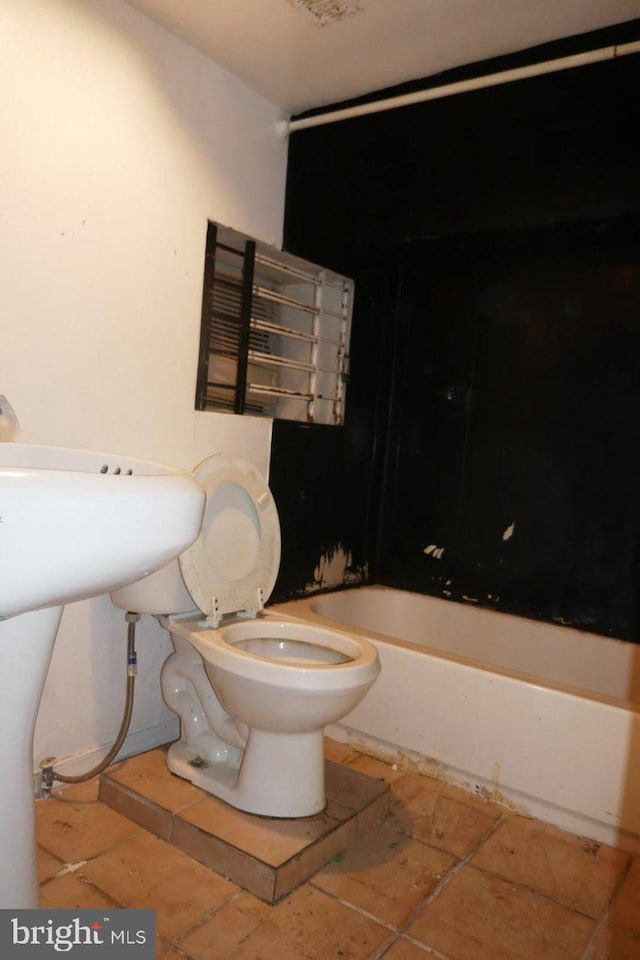 bathroom featuring tile patterned flooring and toilet