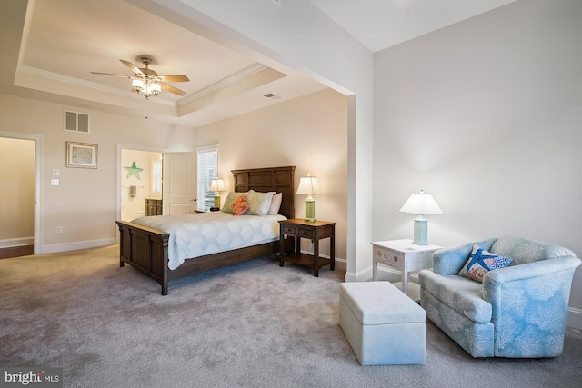 bedroom with carpet flooring, a raised ceiling, ceiling fan, and ornamental molding