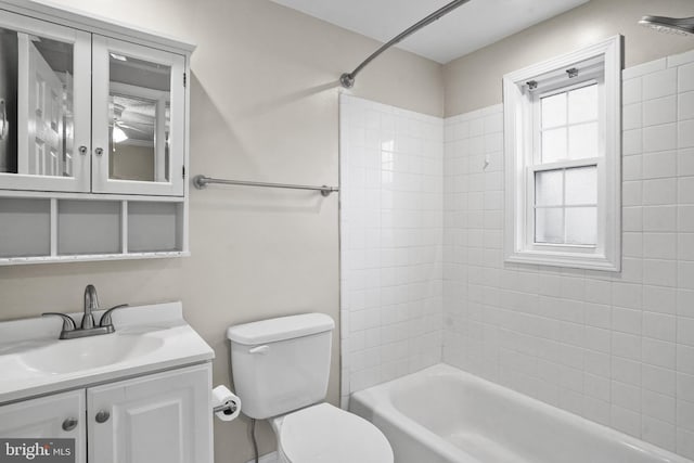 full bathroom with vanity, toilet, and tiled shower / bath