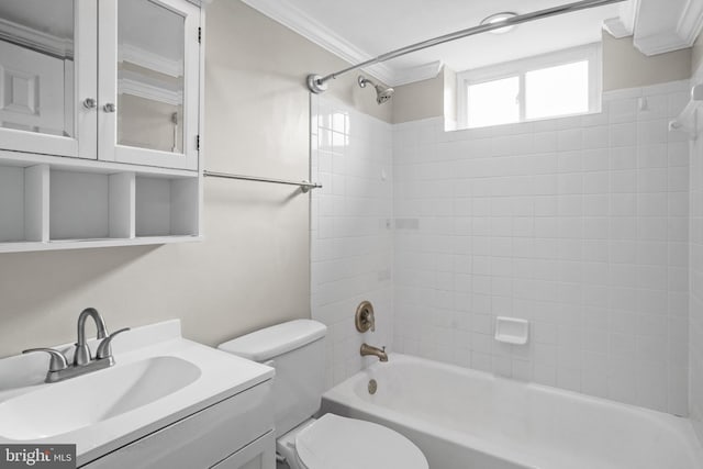 full bathroom featuring vanity, toilet, ornamental molding, and tiled shower / bath