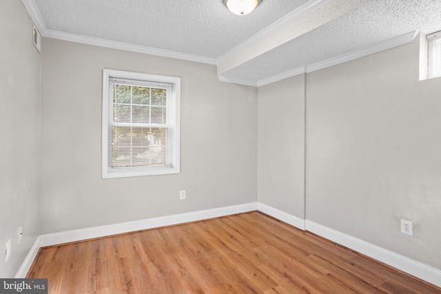 unfurnished room with wood-type flooring, a textured ceiling, and crown molding