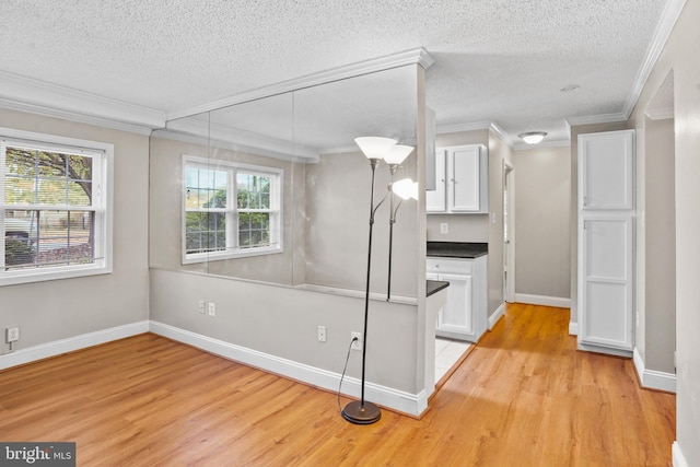 bathroom featuring hardwood / wood-style flooring, ornamental molding, and a textured ceiling