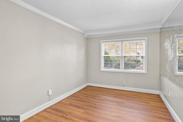 empty room with crown molding, a textured ceiling, and light wood-type flooring