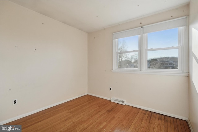 spare room with light hardwood / wood-style flooring