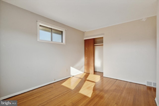 spare room with light hardwood / wood-style flooring