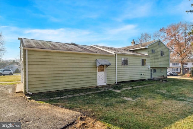 back of house with a yard