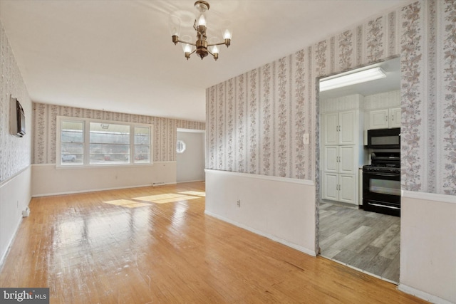 interior space with light hardwood / wood-style floors and an inviting chandelier