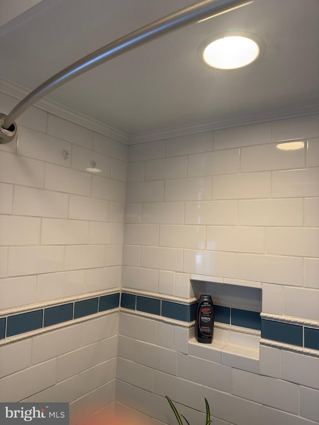 bathroom with a shower and crown molding