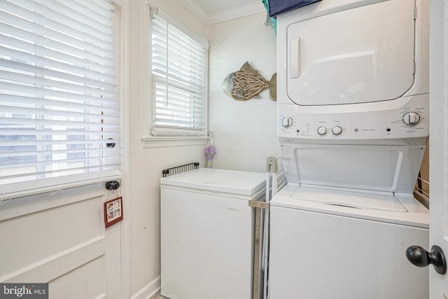 laundry room with a healthy amount of sunlight, ornamental molding, and stacked washer / dryer