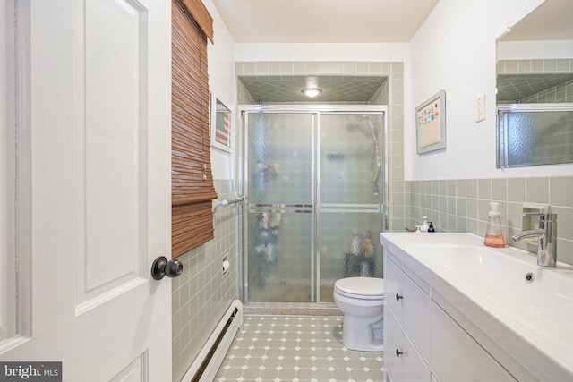 bathroom with walk in shower, vanity, a baseboard radiator, tile walls, and toilet