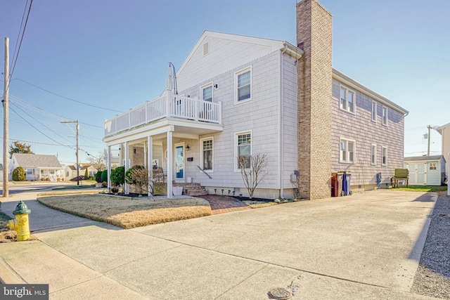 view of front of property featuring a porch and a balcony