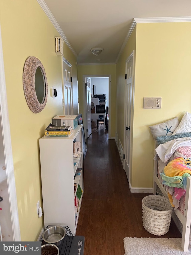 hall featuring dark wood-type flooring and ornamental molding