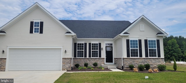 view of front of house with a front lawn and a garage