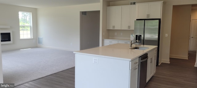 kitchen with white cabinetry, sink, an island with sink, and wood-type flooring