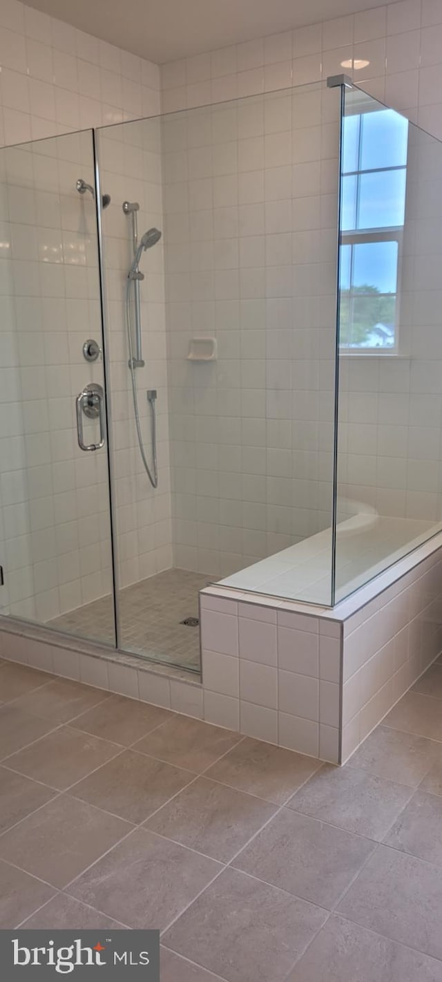 bathroom with tile patterned flooring and an enclosed shower