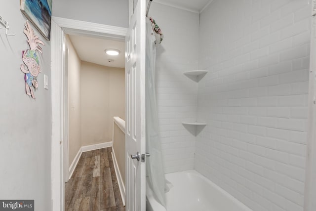 bathroom with shower / bath combo with shower curtain and hardwood / wood-style floors