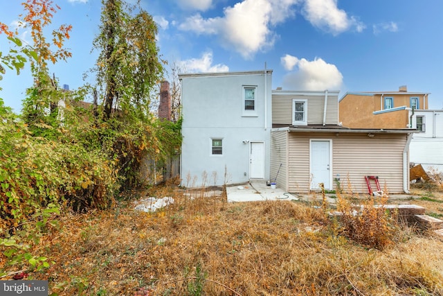 rear view of property featuring a patio