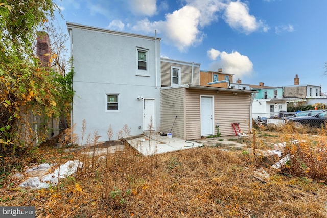 back of property featuring a patio area