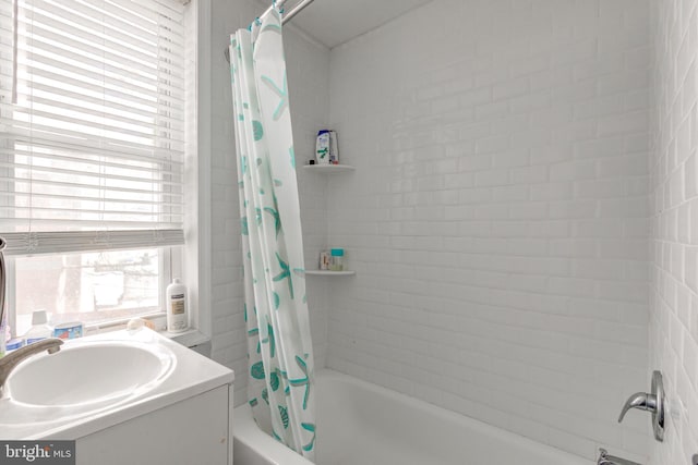 bathroom with vanity and shower / tub combo with curtain