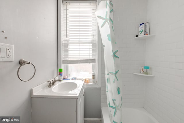 bathroom featuring shower / bath combo and vanity