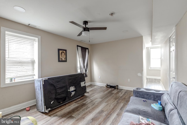 living room with hardwood / wood-style floors, ceiling fan, and a healthy amount of sunlight