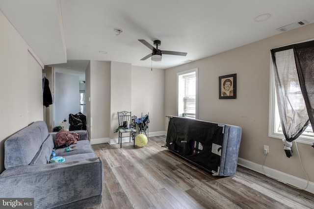 living room featuring hardwood / wood-style floors and ceiling fan